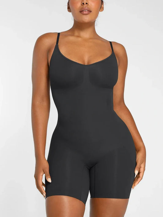 A woman wearing a black smoothing seamless full body shaper with shorts.
